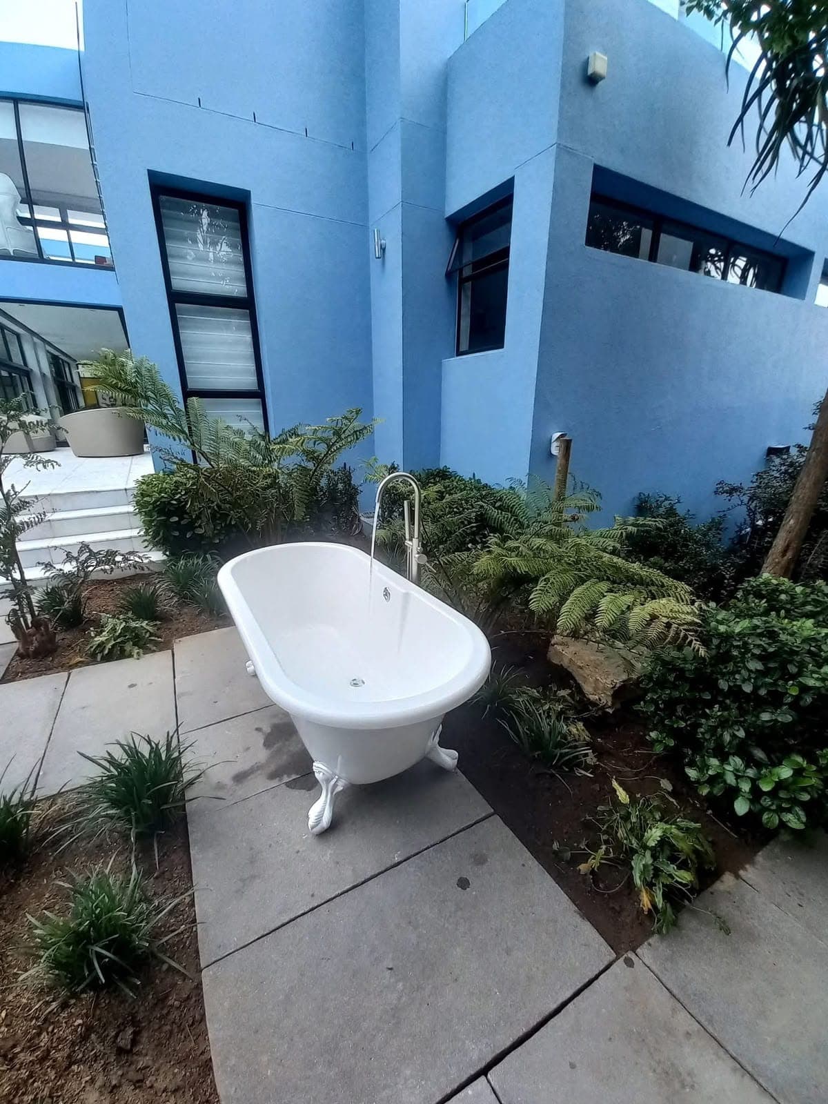 Freestanding outdoor bath and floor-mounted filler installed by Pace Plumbing